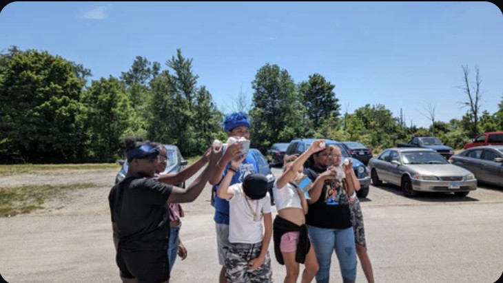 Campers watching a launch through eclipse glasses